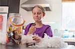 Girl secretly enjoying biscuit from biscuit barrel