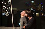 Young couple embracing at rooftop party