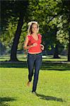 Young blond woman running in a park