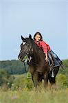 Girl on an Arabian Haflinger on a meadow