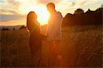 Couple at sunset on field