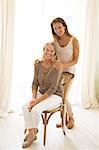 Mother and daughter smiling at window