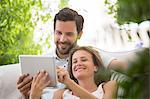 Couple using digital tablet outdoors