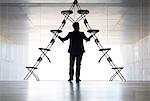 Businessman arranging office chair installation art