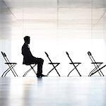 Silhouette of businessman sitting in office