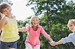 Grandmother and grandchildren playing outdoors