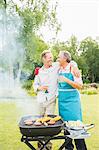 Men hugging at barbecue in backyard