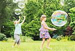 Children playing with bubbles outdoors