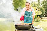 Man grilling food on barbecue in backyard