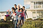 Family walking on beach path outside house