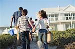 Brother and sister holding hands on beach path