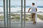 Man looking at ocean view from deck