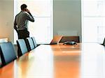 Businessman talking on cell phone in conference room