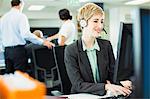 Businesswoman talking on headset in office