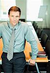 Businessman sitting at edge of conference table