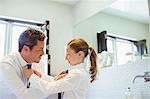 Father and daughter tying each other's ties