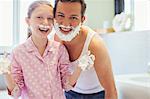 Father and daughter playing with shaving cream