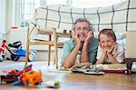 Father and son reading together