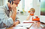 Father and son working in home office