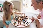 Father and daughter playing Chinese checkers