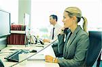 Businesswoman talking on telephone in office