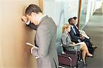 Businessman leaning on office door