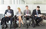 Business people reading in waiting area