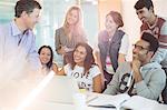 University students talking with teacher in classroom