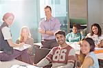 Professor and university students smiling in classroom