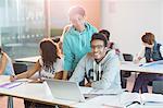 University students using laptop in classroom