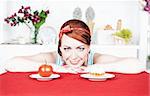 Smiling beautiful woman choosing between healthy food and cake