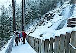 Alps beautiful mountain waterfall Krimml (Austria, Tirol) winter view with family on observation point.