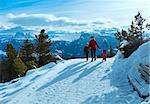 Family (mother with  two children) take a walk on winter mountain slope (Rittner Horn, Italy)