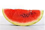 A slice of fresh watermelon on table isolated on white