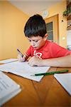 boy doing school homework from mathematics in workbook