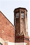 The guard tower over the main gate entrance to the Seodaemun Prison in Seoul, Korea stands over the main prison yard.