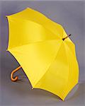 opened yellow umbrella isolated on gray background