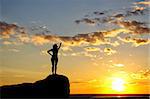 silhouette of a young girl in a cowboy hat on the sunny sky background