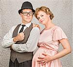 Cute smiling confident pregnant 1950s retro couple