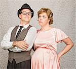 Proud 1950s man with bored pregnant woman
