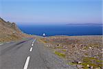 Road in Varanger, extreme north of Norway during summer with Barents Sea in the view