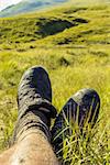 Taking a rest after a hike through a wet, muddy grassfield