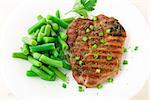 Delicious beef steak with green beans on a plate