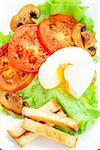 Light breakfast with soft egg, tomato and croutons on a white plate
