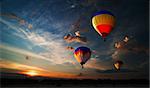 Colorful hot air balloon is flying at sunrise