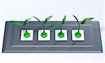 four green plugs with the cables that take the form of small plants are inserted into sockets placed in a lucid grey support panel, on a white background