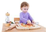 cute girl making pizza isolated in white background