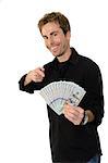 A young handsome man holding a lot of new hundred dollar bills isolated on white background.  This newly redesigned US currency was released for circulation in October of 2013.