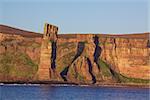 Red sandstone with visible layers on the cliffs of Orkney coast