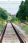Railway tracks in green country. Selective focus on front.